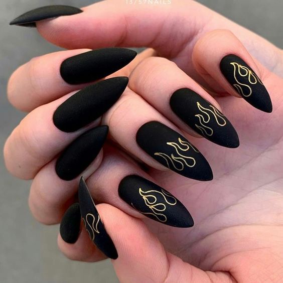 gold and black pointy nails